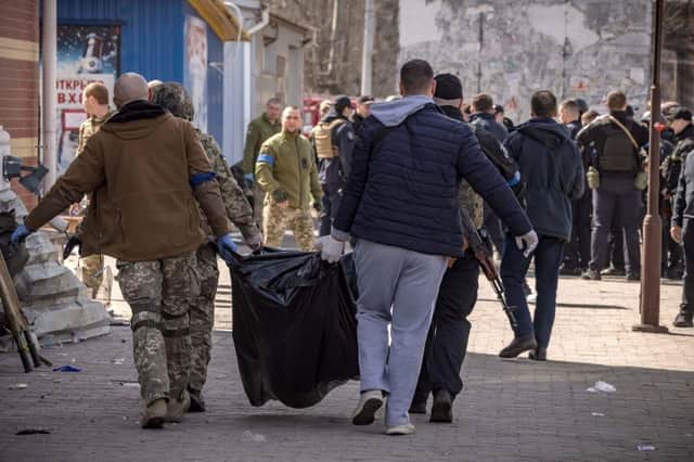 Ukrainian soldiers clear out bodies after a rocket attack killed 50 people at a train station in Kramatorsk, eastern Ukraine.