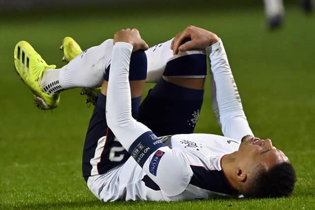 James Tavernier in agony after suffering the knee injury in Antwerp on February 18 which saw him miss 10 games for Rangers before his return this week. (Photo by DIRK WAEM/BELGA/AFP via Getty Images)
