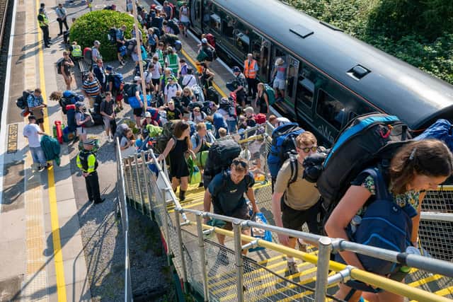 Revellers arrive at Castle Cary train station as they make their way off the platform and onto the busses that will shuttle them to Glastonbury Festival at Worthy Farm in Somerset. Photo: Ben Birchall/PA Wire