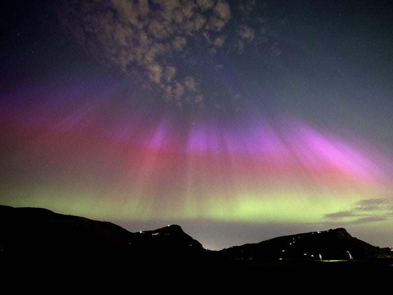 The aurora borealis, also known as the northern lights, above Arthur’s Seat and Salisbury Crags in Holyrood Park