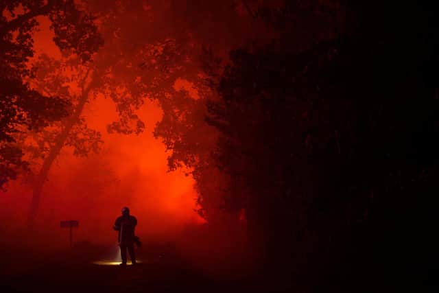 A firefighter faces the flames of a massive wildfire in the Gironde region, in southwestern France, this week. Picture: Philippe Lopez/Getty Images