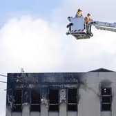 Firefighters survey the roof after a fire at Loafers Lodge in Wellington, New Zealand. Picture: Hagen Hopkins/Getty Images