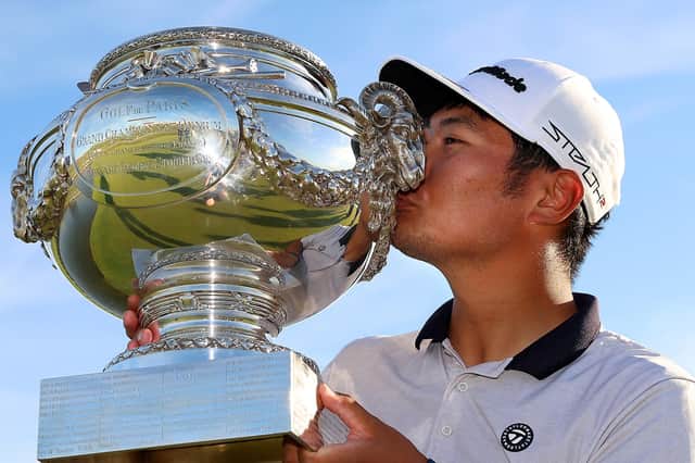 Ryo Hisatsune of Japan celebrates with the trophy after winning the Cazoo Open de France at Le Golf National.