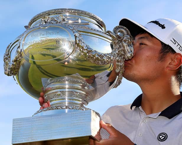 Ryo Hisatsune of Japan celebrates with the trophy after winning the Cazoo Open de France at Le Golf National.