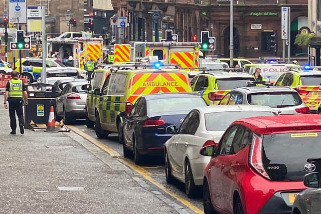 There is a heavy police presence on West George Street with more than a dozen police vehicles in attendance. Pic:L JATV_scotland/PA Wire