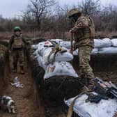 Ukrainian soldiers Mykhailo, left, and Pavlo build a bunker on the front line with Russian-backed separatists in Zolote, Ukraine, last month (Picture: Brendan Hoffman/Getty Images)