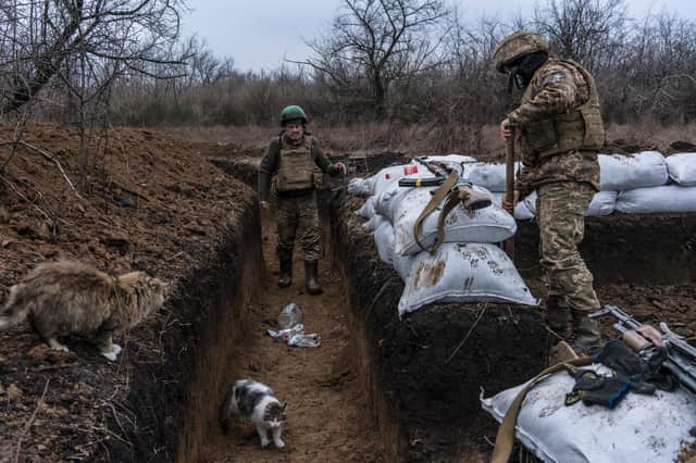 Ukrainian soldiers Mykhailo, left, and Pavlo build a bunker on the front line with Russian-backed separatists in Zolote, Ukraine, last month (Picture: Brendan Hoffman/Getty Images)