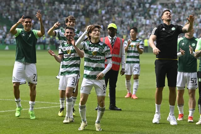 The Celtic players take the acclaim of the home support after taking down Rangers 2-1 at Parkhead.
