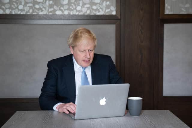 Prime Minister Boris Johnson prepares his keynote speech in his hotel room in Manchester before addressing the Conservative Party Conference on Wednesday.