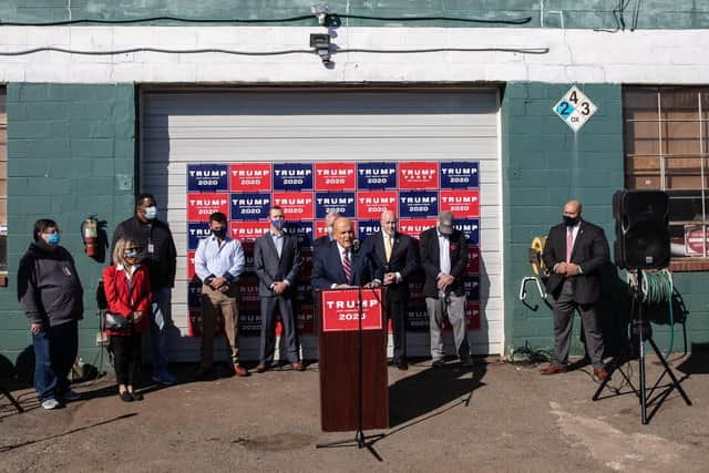 Rudy Giuliani speaks to the media in the back parking lot of Four Seasons Total Landscaping in Philadelphia. Photograph: Chris McGrath/Getty Images