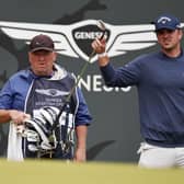 Will Gordon selects a club from his bag as his caddie, Glasgow man Jeffrey Paul, looks on from the 18th green during day one of the Genesis Scottish Open at The Renaissance Club. Picture: Jared C. Tilton/Getty Images.