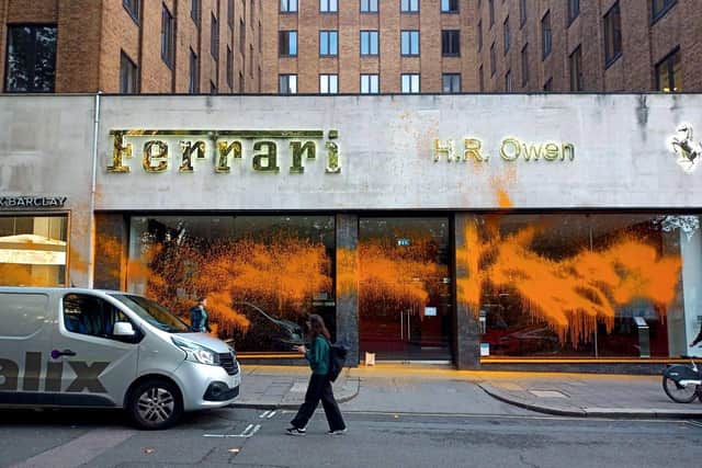 Handout photo issued by Just Stop Oil of the HR Owen car showroom on Berkley Square in central London which has been sprayed with paint by Just Stop Oil protesters. Picture date: Wednesday October 26, 2022.