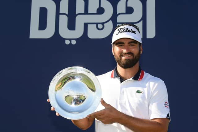 Frenchman Antoine Rozner celebrates with the trophy following his victory in the Golf in Dubai Championship at Jumeirah Golf Estates. Picture: Ross Kinnaird/Getty Images