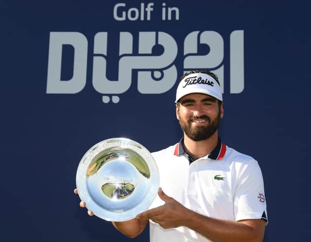 Frenchman Antoine Rozner celebrates with the trophy following his victory in the Golf in Dubai Championship at Jumeirah Golf Estates. Picture: Ross Kinnaird/Getty Images