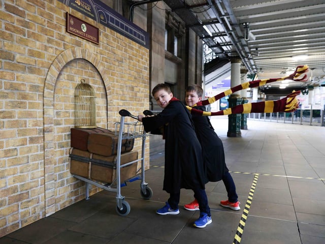 Twins Harris and Ethan Christie, both 9, pose with the Harry Potter Platform 9 ¾ trolley that was unveiled at Edinburgh Waverley train station. Following this, the trolley will tour stations across the UK and Ireland, to celebrate the 20th anniversary of Harry Potter and the Philosopher’s Stone release in UK cinemas. It will magically pop up in Birmingham, Cardiff, Belfast and Dublin.