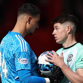 Aberdeen's Kelle Roos (L) speaks with Hibs' Kevin Nisbet (R) before he misses a penalty at Pittodrie.