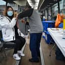 Members of the public receive vaccinations on a vaccination bus at West College Scotland Clydebank Campus on December 17, 2021 in Glasgow, Scotland. Photo by Jeff J Mitchell/Getty Images