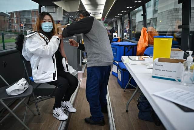 Members of the public receive vaccinations on a vaccination bus at West College Scotland Clydebank Campus on December 17, 2021 in Glasgow, Scotland. Photo by Jeff J Mitchell/Getty Images