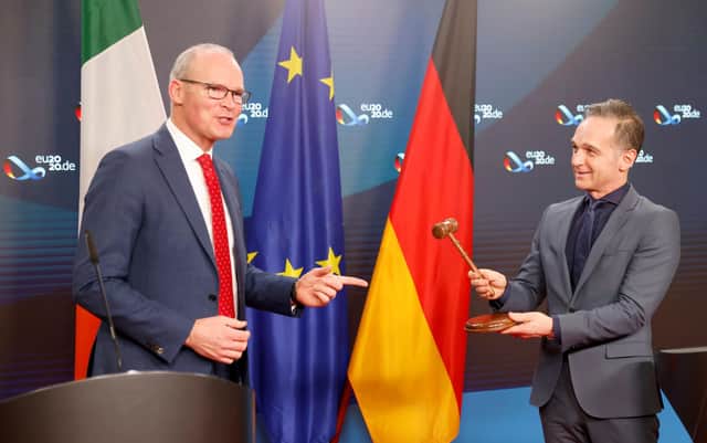 German foreign minister Heiko Maas gives a hammer to his Irish counterpart Simon Coveney to mark the Irish presidency of the United Nations Security Council (Picture: Fabrizio Bensch/pool/AFP via Getty Images)