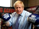 Photo taken on November 19, 2019 - Boris Johnson wears boxing gloves emblazoned with "Get Brexit Done" Photo by Frank Augstein via Getty Images