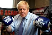 Photo taken on November 19, 2019 - Boris Johnson wears boxing gloves emblazoned with "Get Brexit Done" Photo by Frank Augstein via Getty Images