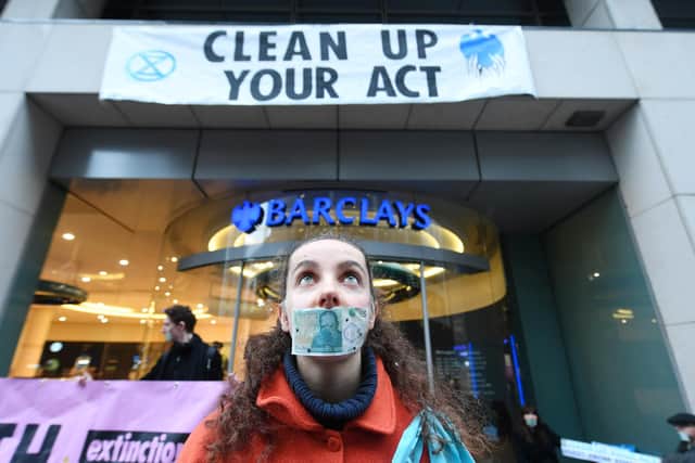 Climate change protesters demonstrate outside a branch of Barclay's bank in Glasgow (Picture: John Devlin)