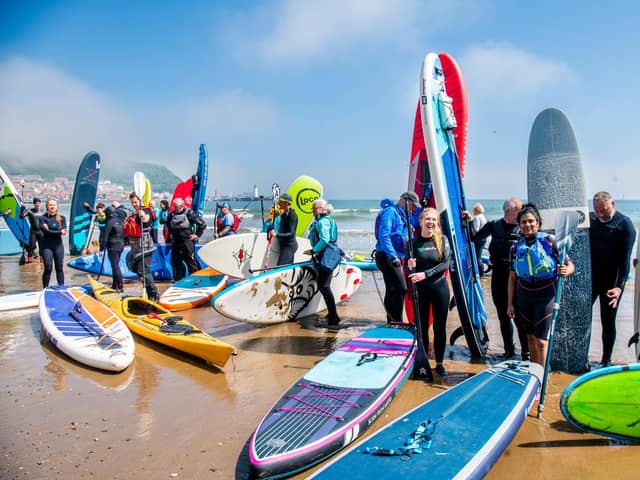 A group of surfers, paddleboarders, and wild swimmers protesting about water quality at Scarborough. This weekend thousands will take to coasts and rivers across the UK to protest about the state of the nation's waterways. PIC: James Hardisty