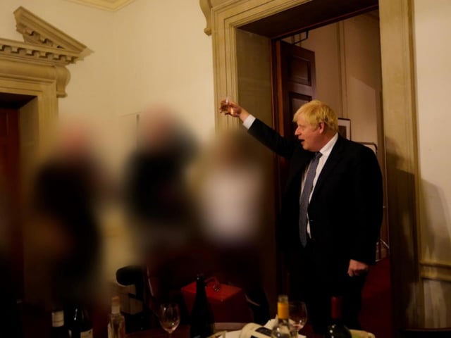 Mr Johnson raises a toast during a gathering at No 10 Downing Street.