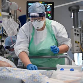 A member of staff at University Hospital Monklands tends to a Covid-positive patient in the intensive care unit earlier this month (Picture: Jeff J Mitchell/Getty Images)