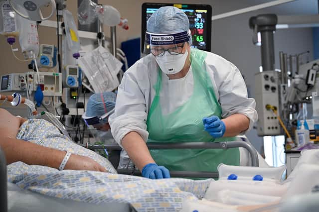 A member of staff at University Hospital Monklands tends to a Covid-positive patient in the intensive care unit earlier this month (Picture: Jeff J Mitchell/Getty Images)