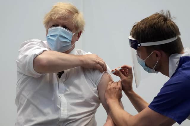 Prime Minister Boris Johnson receiving his second jab of the AstraZeneca vaccine from James Black, at the Francis Crick Institute in London on Thursday.