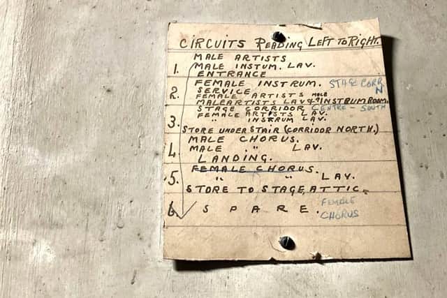 The original hand-written guide to the electrical circuits remains in the backstage fuse box