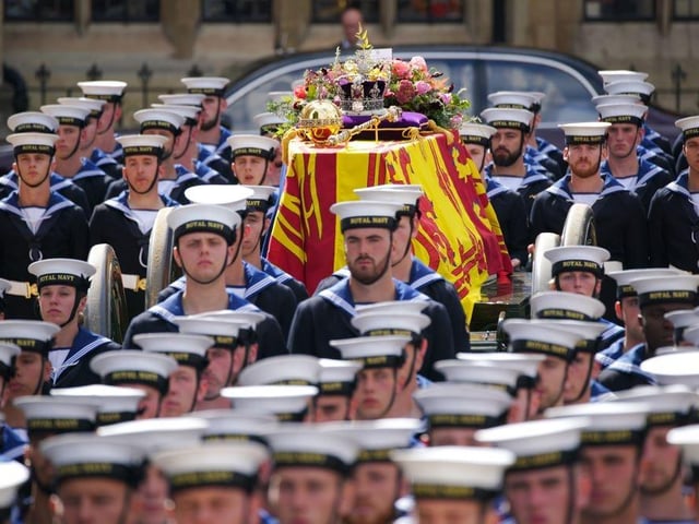The State Gun Carriage carries the coffin of Queen Elizabeth II, draped in the Royal Standard with the Imperial State Crown and the Sovereign's orb and sceptre with a message from King Charles III