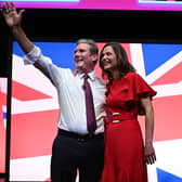 Keir Starmer and his wife Victoria Starmer stand on stage after his keynote address to delegates (Photo by OLI SCARFF/AFP via Getty Images)