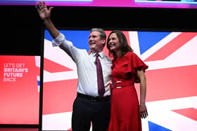 Keir Starmer and his wife Victoria Starmer stand on stage after his keynote address to delegates (Photo by OLI SCARFF/AFP via Getty Images)
