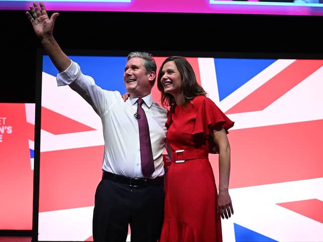 Keir Starmer and his wife Victoria Starmer stand on stage after his keynote address to delegates (Photo by OLI SCARFF/AFP via Getty Images)