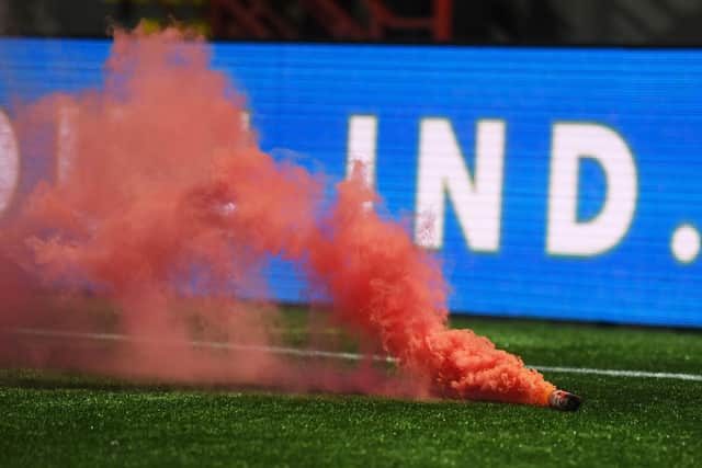 A smoke bomb is thrown onto the pitch during a Scottish Cup match between Hamilton Accies and Hearts at the ZLX Stadium.