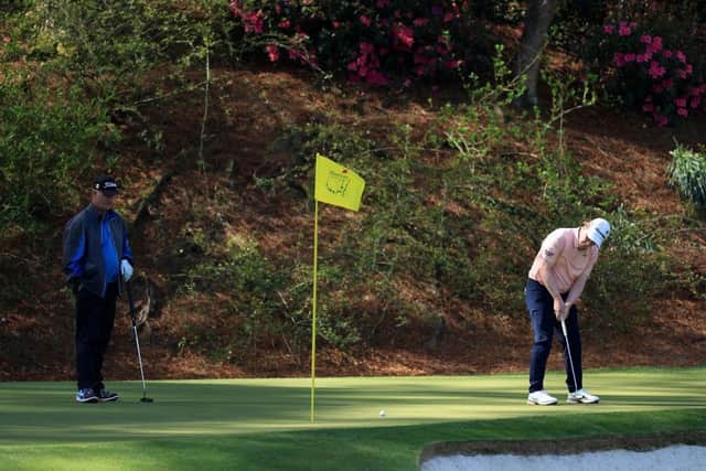 Bob MacIntyre putts on the 12th green as Sandy Lyle looks on during a practice round prior to the Masters at Augusta National Golf Club. Picture: David Cannon/Getty Images.