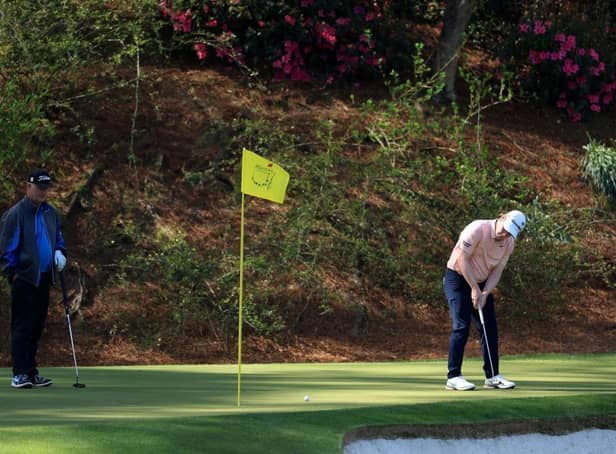 Bob MacIntyre putts on the 12th green as Sandy Lyle looks on during a practice round prior to the Masters at Augusta National Golf Club. Picture: David Cannon/Getty Images.