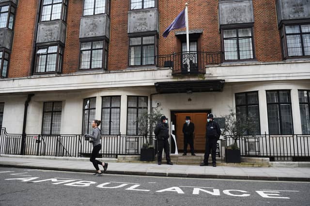 Police officers and hospital security staff stand at the entrance to the King Edward VII Hospital in London where the Duke of Edinburgh will remain until at least next week.