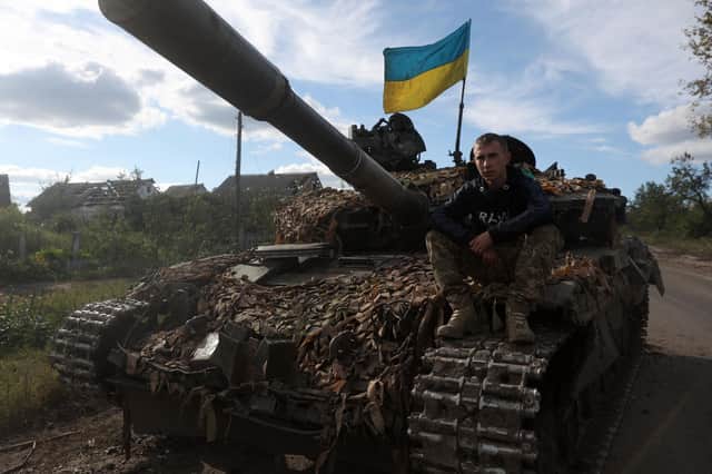A Ukrainian serviceman sits on a tank near the recently retaken village of Dolina in the Donetsk region, which Russia plans to annex today (Picture: Anatolii Stepanov/AFP via Getty Images)