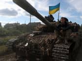 A Ukrainian serviceman sits on a tank near the recently retaken village of Dolina in the Donetsk region, which Russia plans to annex today (Picture: Anatolii Stepanov/AFP via Getty Images)