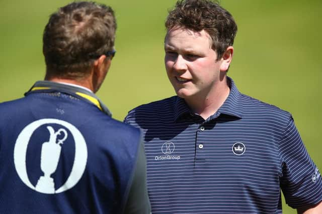 Bob Macintyre with his caddie Mike Thomson after holing a birdie putt at the 18th in the second round at Royal St George's. Picture: Christopher Lee/Getty Images.