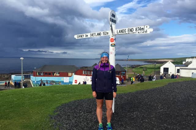 Elise Downing at John O'Groats, a landmark point in her run.