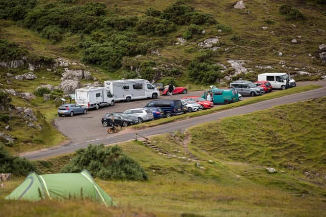 A car park and lay-by close to Ullapool on the North Coast 500, pictured in July 2020 as some lockdown restrictions eased. The popularity of motorhomes and roadside camping in parts of Scotland has intensified since the pandemic with solutions sought to the impact to local communities and infrastructure. PIC:  Paul Campbell/Getty Images.