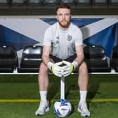 Hearts goalkeeper Zander Clark has been called into the Scotland squad.