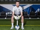 Hearts goalkeeper Zander Clark has been called into the Scotland squad.