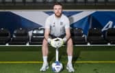 Hearts goalkeeper Zander Clark has been called into the Scotland squad.