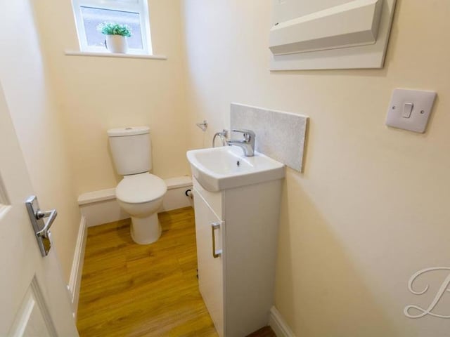 As well as the main bathroom, there is this separate toilet at the Ley Bank bungalow. It features a wash hand basin with storage, low-flush WC and central heating radiator.