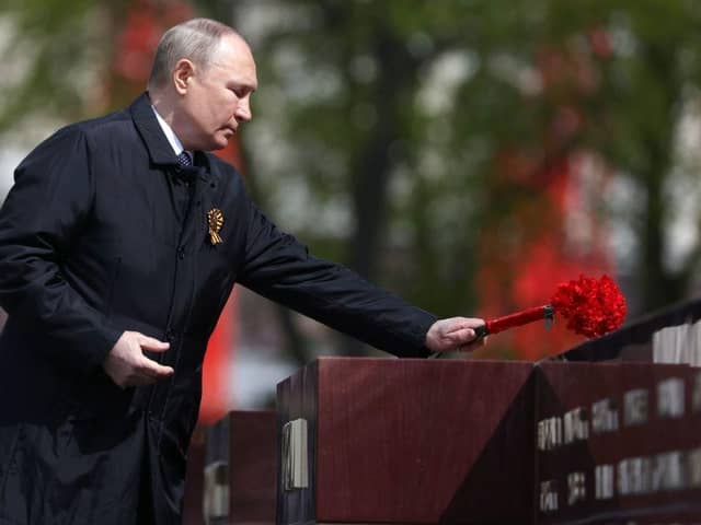 Russian President Vladimir Putin lays flowers at a memorial to the Hero Cities during a ceremony at the Tomb of the Unknown Soldier after the Victory Day military parade in central Moscow. Picture: SPUTNIK/AFP via Getty Images